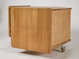 a small wooden box with wheels on a white background