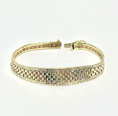 a close up of a gold bracelet on a white surface