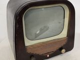 an old fashioned television sitting on a white surface