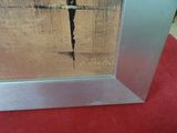 silver picture frame with a cross on it sitting on a red carpet