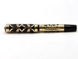 a black and gold pen sitting on top of a white surface