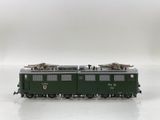 a green train on a white surface with a white background