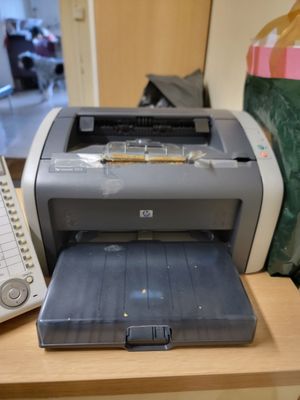 a printer sitting on a desk next to a phone