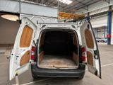 a white van with its doors open in a parking lot
