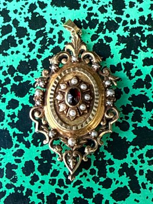 a close up of a broochle on a green surface
