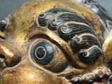 a close up of a statue of a dragon head