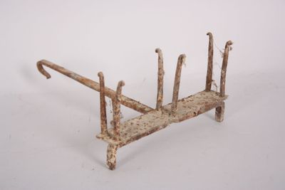 a rusted iron bed frame on a white background