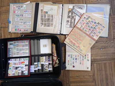 a suitcase full of stamps and papers on the floor