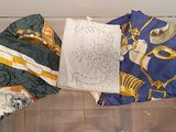 many different types of scarves on display in a glass case