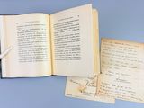 a open book with a pen on top of it
