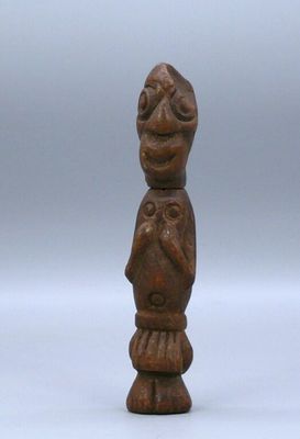 an old wooden figurine of a man with a bird on his shoulder