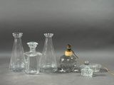 a group of glass vases and a lamp on a table