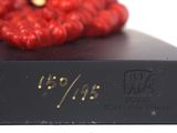 a red flower on top of a black book