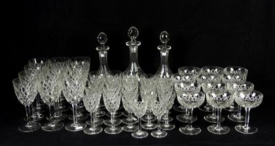 a lot of wine glasses and a decanter on the table