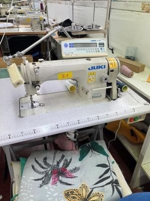 a sewing machine that is on a table in a room