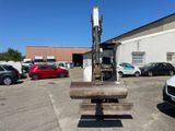 a fork on the back of a forklift in a parking lot