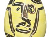 painting of a man ' s face on a yellow egg with black and white lines