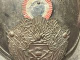 a metal plate with a picture of a sun on it