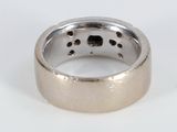 a silver ring with holes in it on a white surface