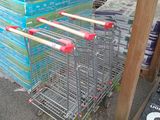 many shopping carts that are stacked up on the street