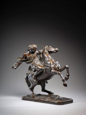 bronze statue of a man riding a horse on a marble base