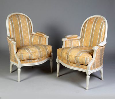 a pair of chairs with striped upholstered upholstered cushions