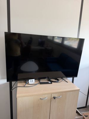 a flat screen tv sitting on top of a wooden cabinet