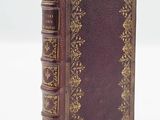 a close up of a book on a white surface with a white background