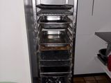 an image of a kitchen with a rack full of food