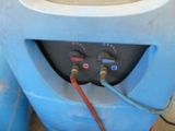 an image of a blue water tank with a hose connected to it