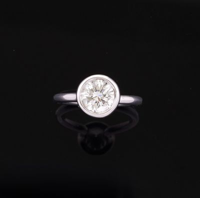 a close up of a diamond ring on a black surface