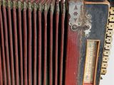 a close up of an old accordion on a white surface