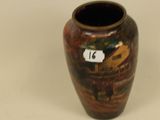 a brown vase with a number on it on a white surface