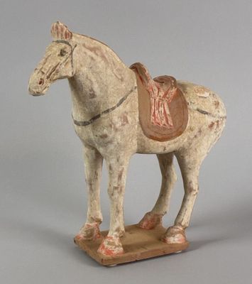 a statue of a horse with a saddle on it ' s back