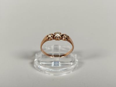 a close up of a gold ring on a clear surface