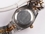 a close up of a watch on a white surface