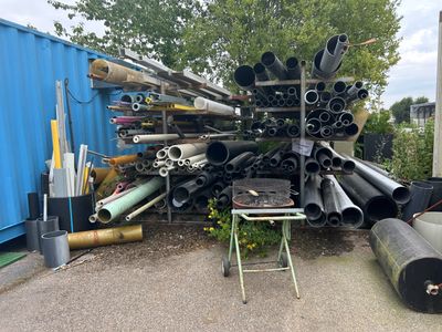 a large pile of pipes and pipes in a yard