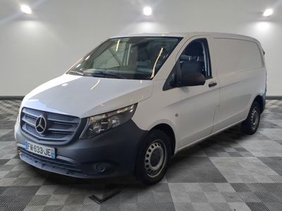the mercedes van is parked on a checkered floor in a garage