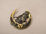 an image of a brooch with a horse on a crescent