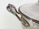 a silver bowl with a handle and a spoon in it