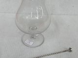 a glass pitcher and a spoon on a table
