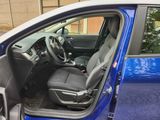 the interior of a blue car with the driver ' s seat up
