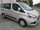the silver van is parked in front of a building
