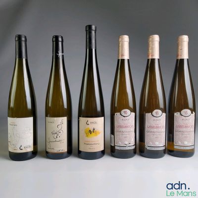 several bottles of wine are lined up on a table