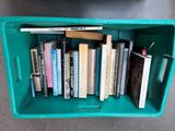 a green box with a bunch of books inside of it