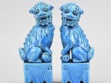pair of blue glazed foo foo dogs sitting on blue boxes