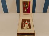 an open book with two pictures of a man and a woman on it