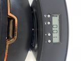 a clock that is on the side of a black speaker