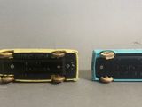 two different colors of electronic devices sitting side by side