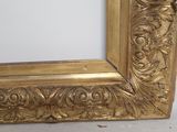 a picture of a gold picture frame on a white surface